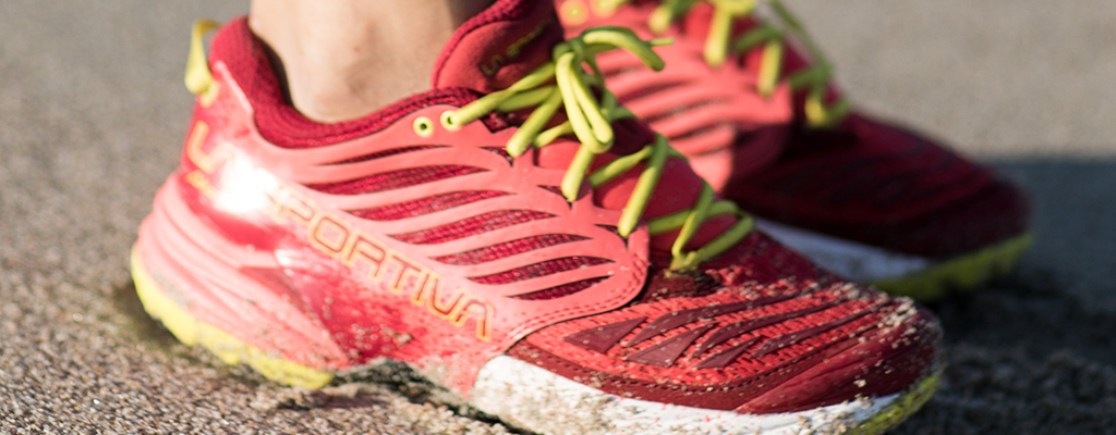 A woman wearing red wide fit trainers 