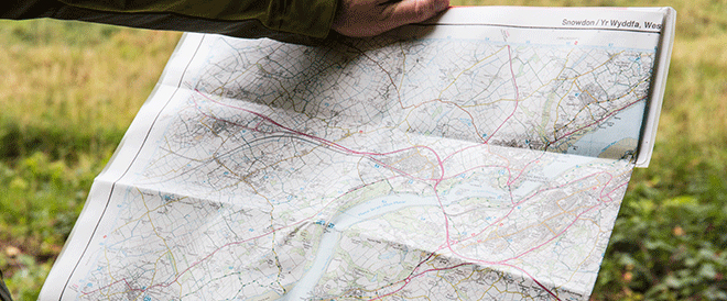 An image of a person holding a map of Snowdon 