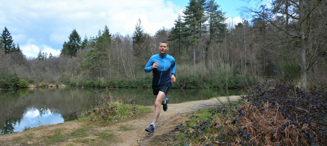 A man running by a lake