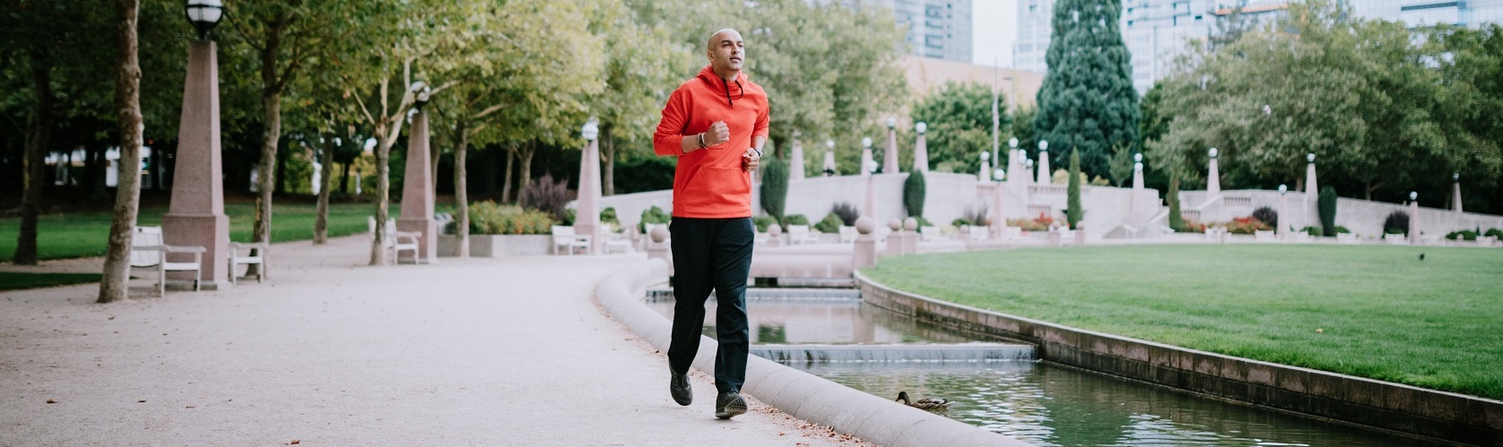 A man running at a slow pace in a park