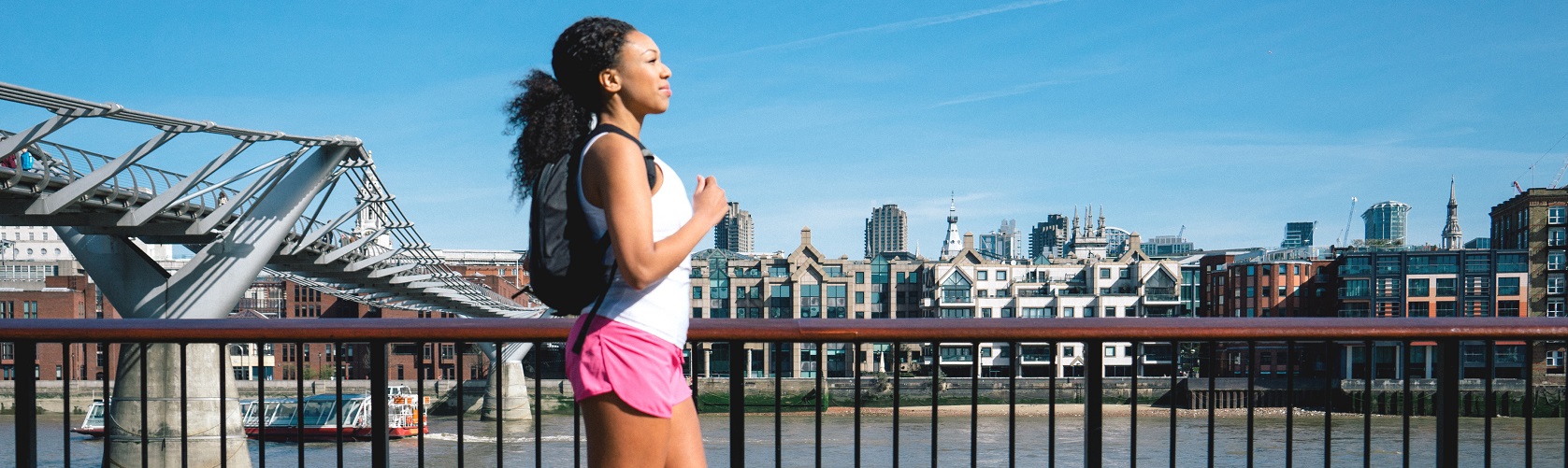 Beautiful woman running in city street.