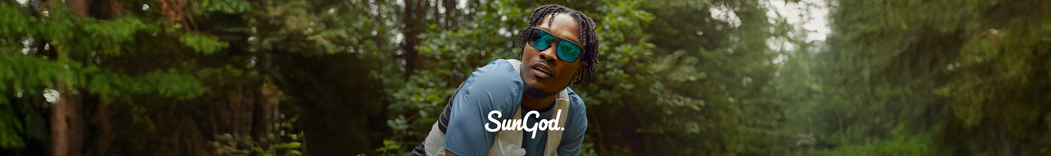 Shop SunGod collection on Runners Need. A man with SunGod sunglassees and runjing pack is having a rest in the woods