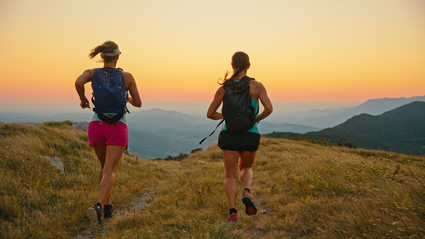 Two trail runners running in the mountains