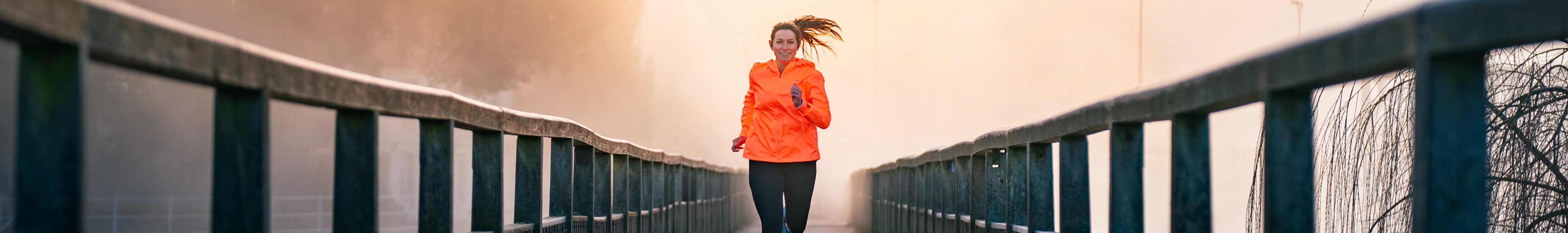 Woman running on a bridge