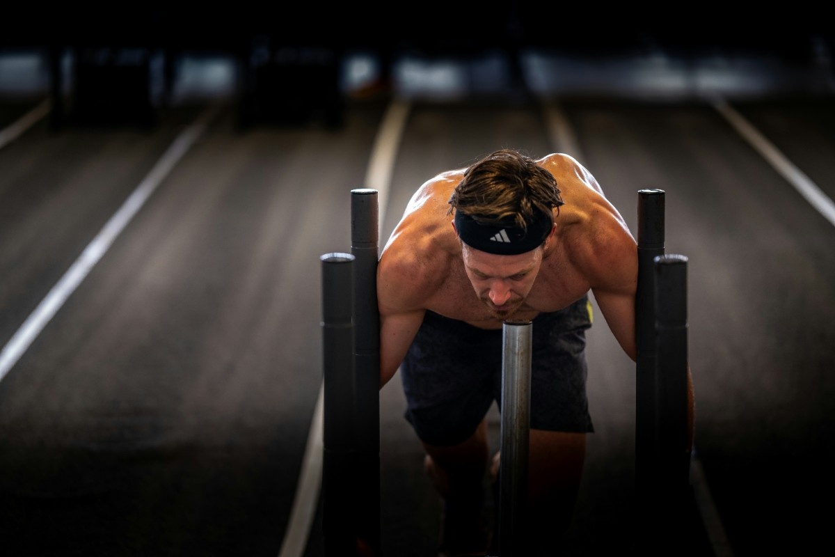 An image of people completing the sled push section of Hyrox