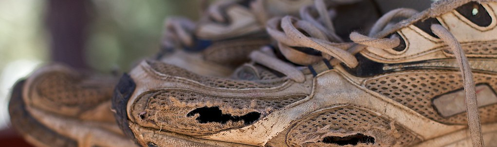 An image of an old worn out running shoes 