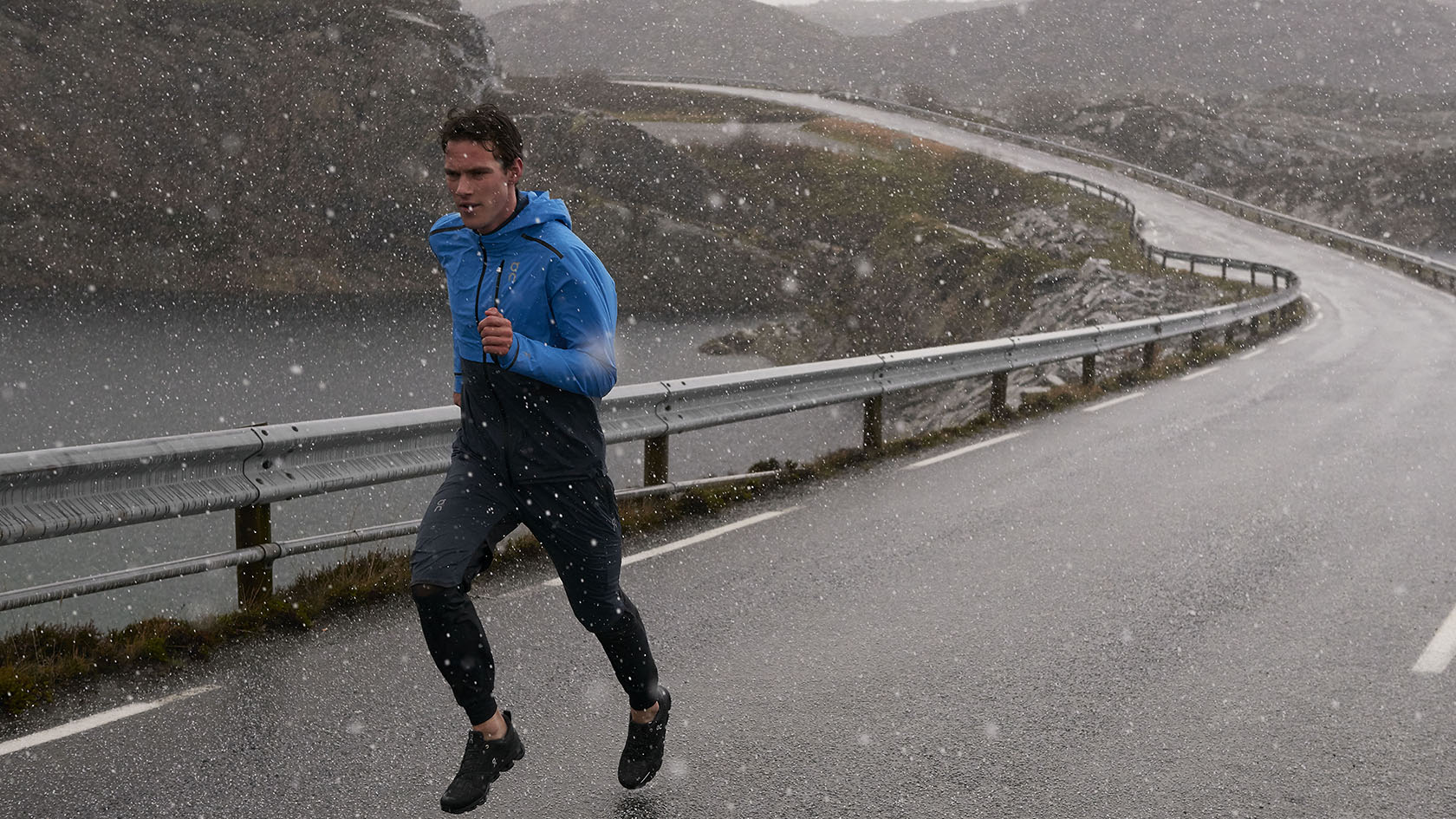 A man running through the rain and snow