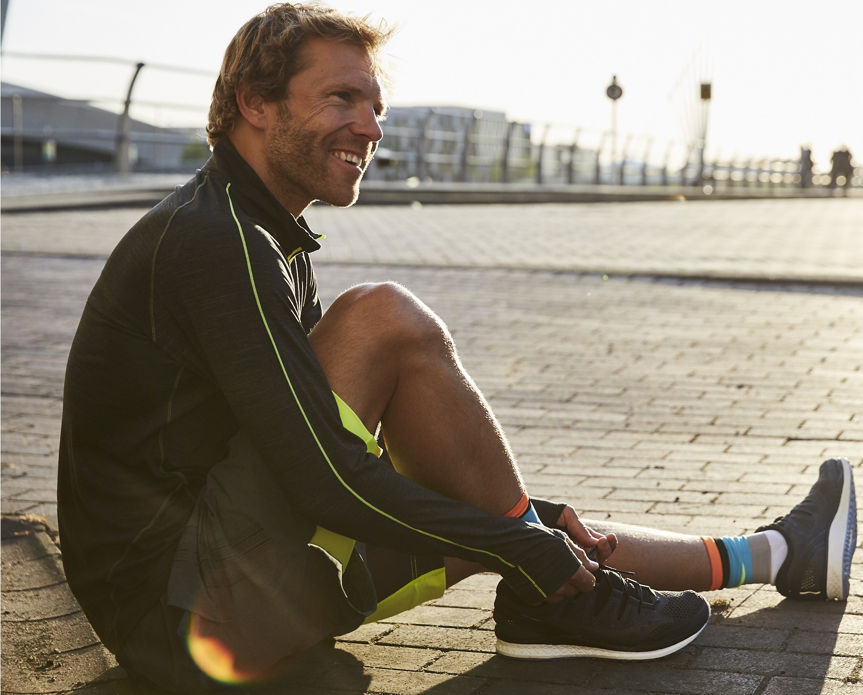 A man stretching his legs after a run 
