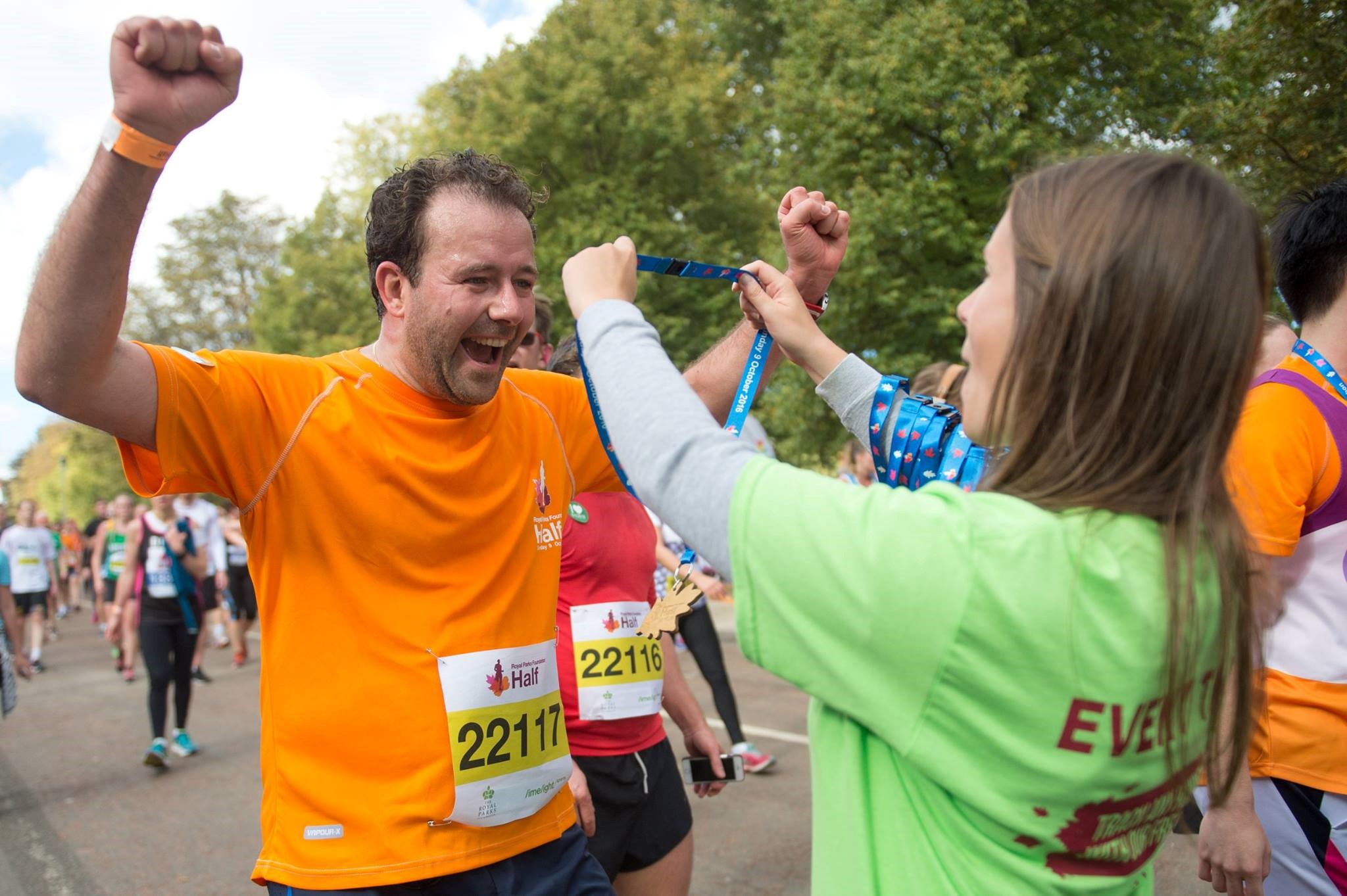 A man receiving a medal for completing his half marathon