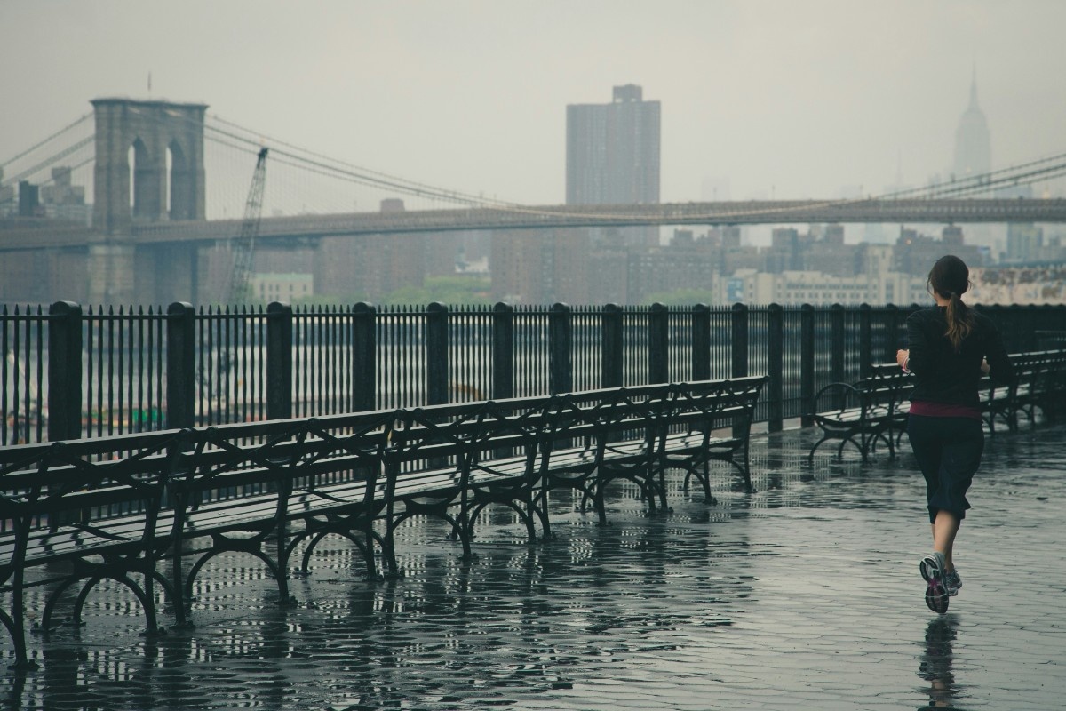A person running through rainy New York in GTX shoes