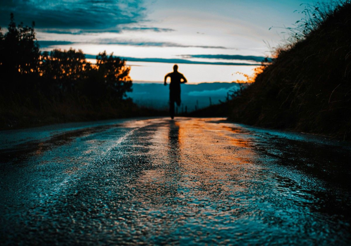 A person running in the rain in their Goretex running shoes