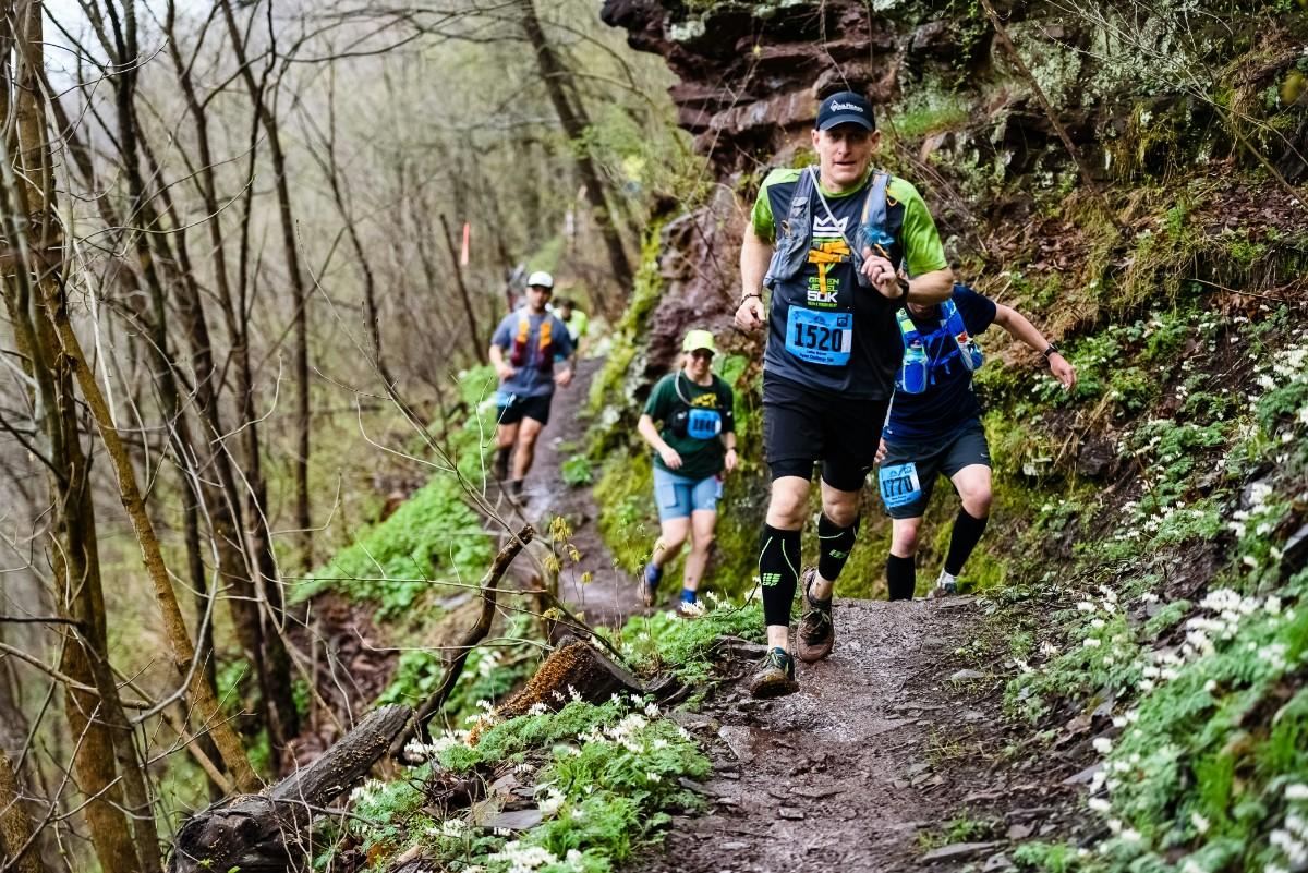 People racing on a trail 
