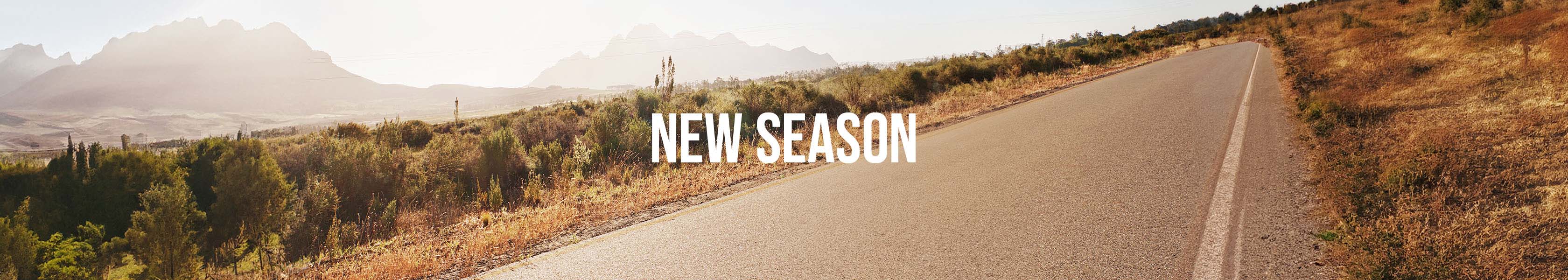 Shop  New Season. New season text over a beautiful running trail 