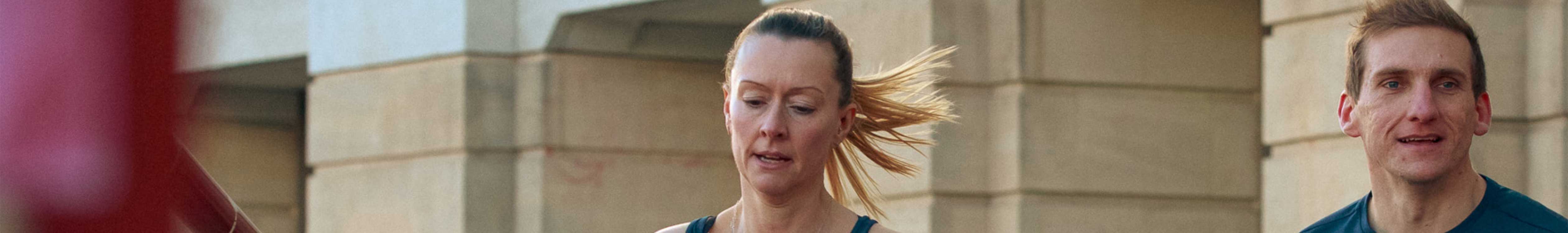 Two people are running in the street