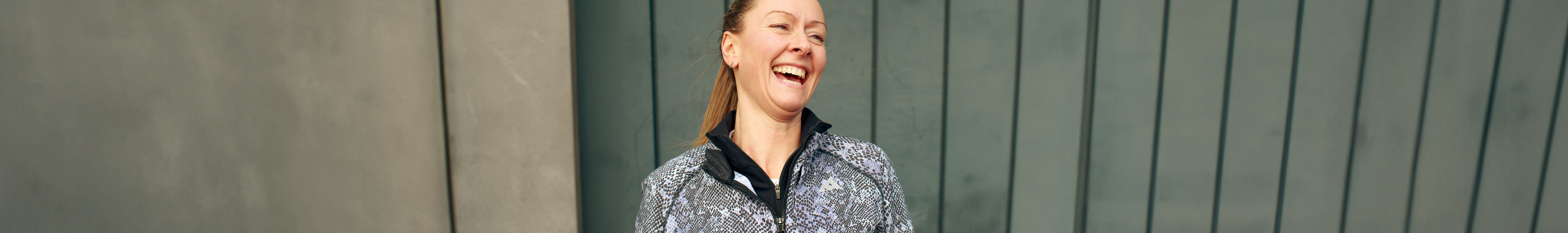 Shop women's running jackets & gilets. A woman wearing black animal print jacket