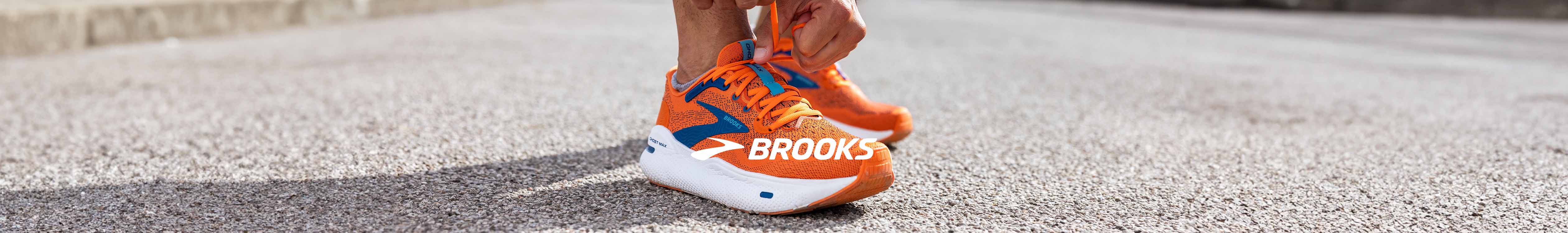 Brooks header. A person tying up their Brooks Ghost Max running shoes