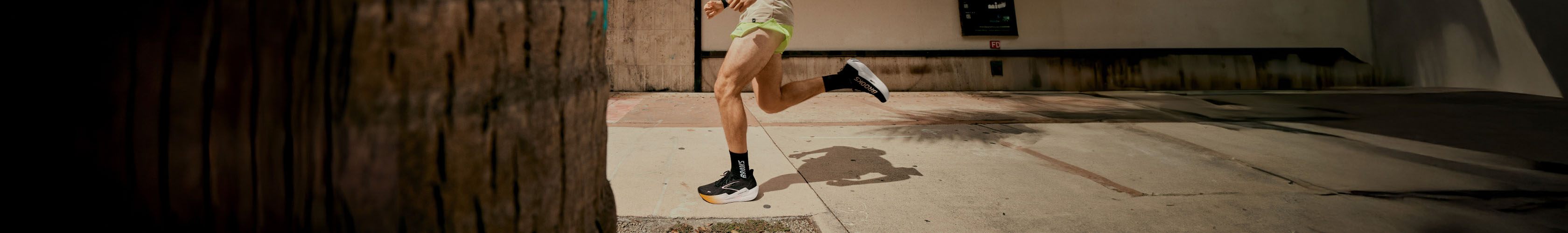 Shop road running shoes. A person running on a road