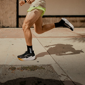 Shop road running shoes. A person running on a road