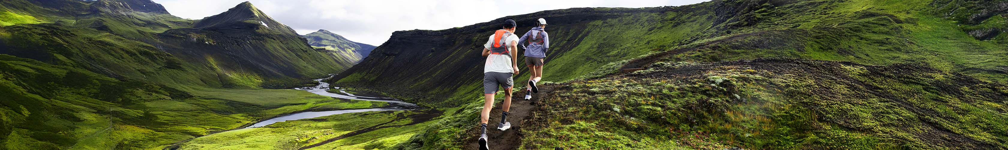 Shop Accessories. Two runners with backpack running up the hill
