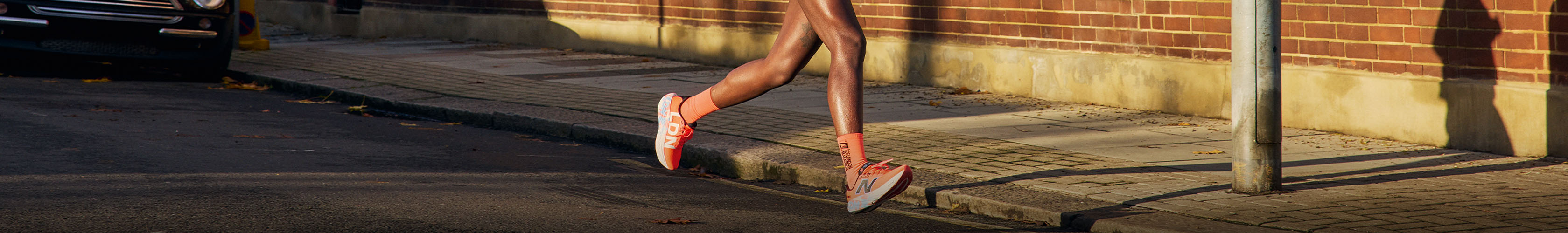 Shop road running shoes. A person running on a road