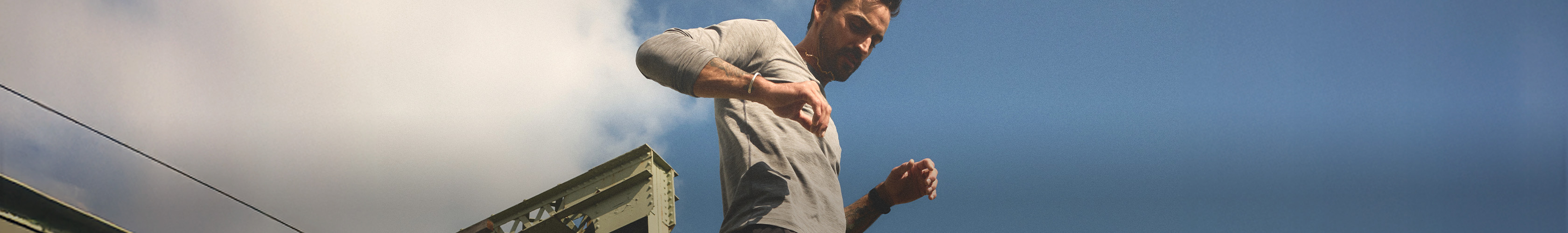 Shop running tops. A man in a grey top