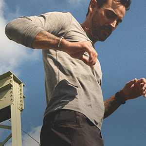 Shop tops. A man wearing a grey top