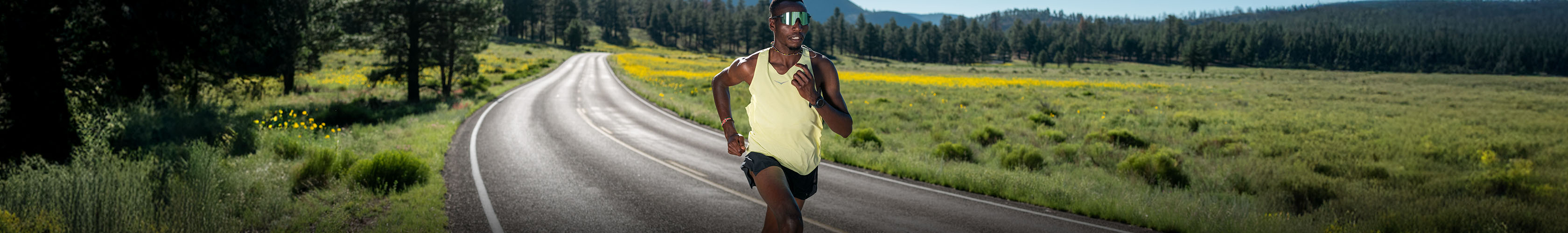 Shop marathon and race essentials. A runner in a yellow T-shirt running on the road