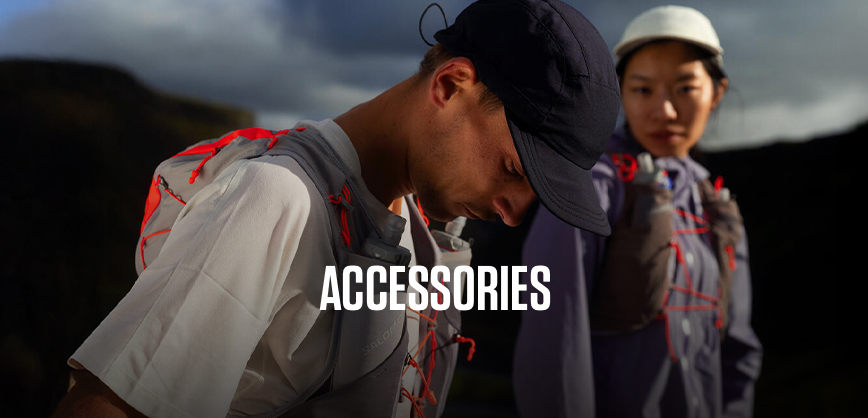 Shop Accessories. Two runners wearing caps and backpack on the hill