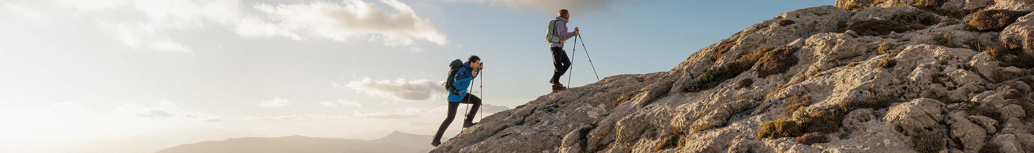 Shop fast hiking in partnership with Cotswold Outdoor. Two people fast hiking up the mountain