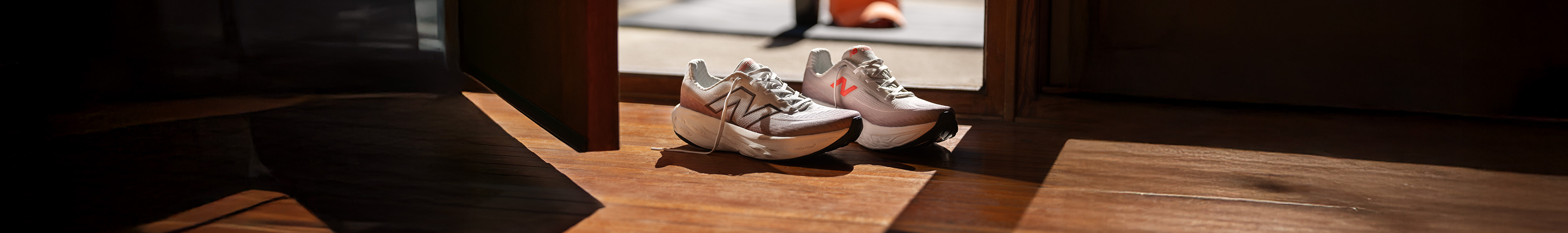 Shop New Balance 1080 v14 running shoes. A pair of NB trainers by the door