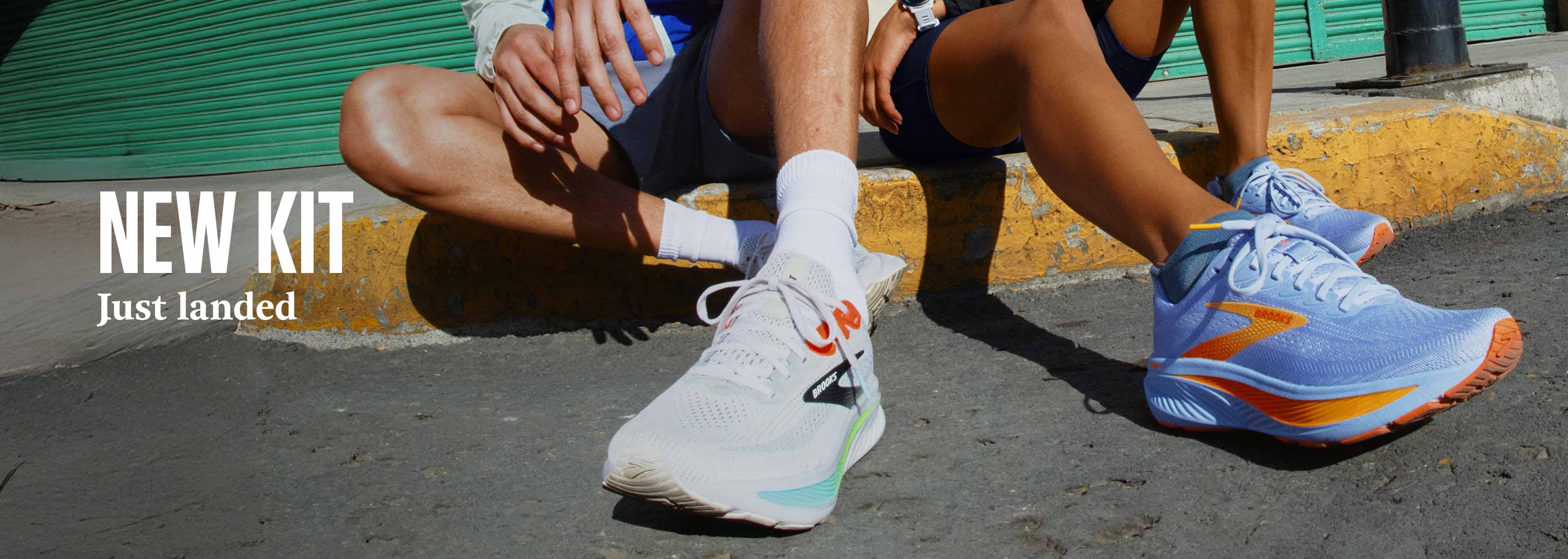 Shop new arrivals on Runners need. Two people in running shoes sitting on the edge of the road