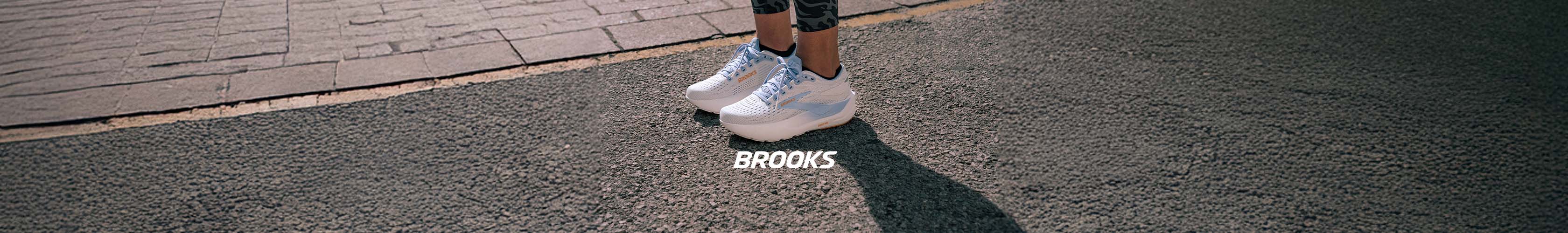 Shop Brooks Cascadia 19. A pair of Brooka Cascadia running shoes on an abstract background