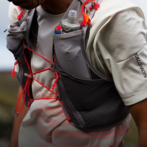 Shop running packs & vests. A close up of running water pack on runners torso 