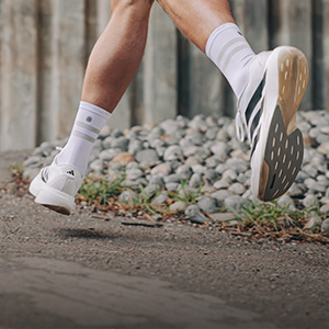 Shop Socks. A pair of runners feet wearing running shoes and socks
