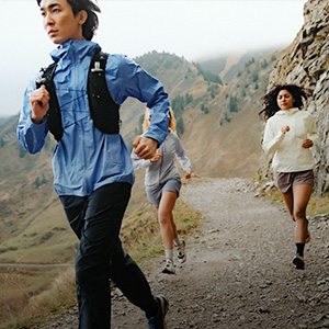 Shop trail running gear. A group of runners running on a dirth path