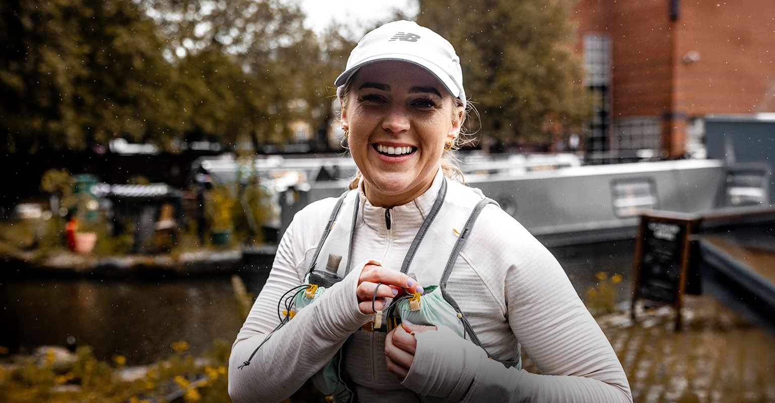 Shop women's running gear. A woman running on the street