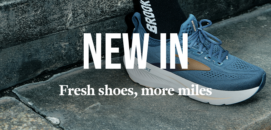 Shop Men's sale. A man in a blue T-shirt running on the street