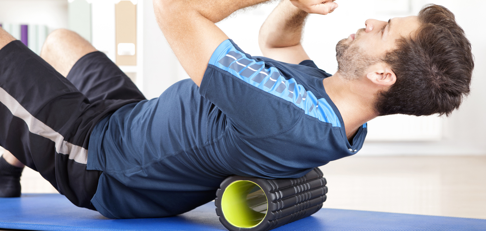 man using a foam roller for his back